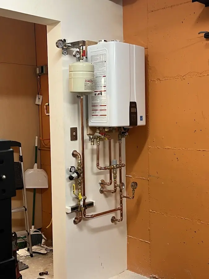 Plumbing technician inspecting water heater connections in Pasadena